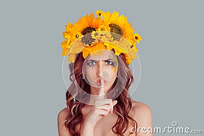 Woman with floral headband wide eyed asking for silence, secrecy Stock Photo