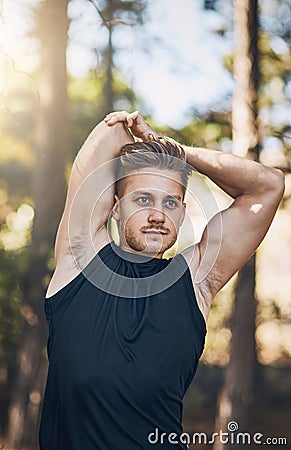 Hustle for that muscle. a young man stretching outdoors. Stock Photo