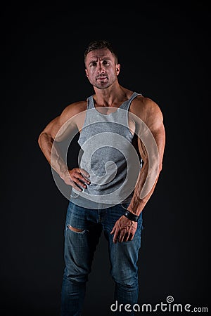 Hustle to gain more muscle. Fit guy with muscular arms black background. Sportsman show biceps triceps in casual wear Stock Photo