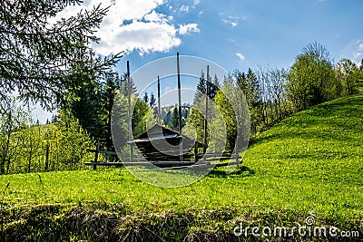 Hutsul hay barn on a green field Stock Photo