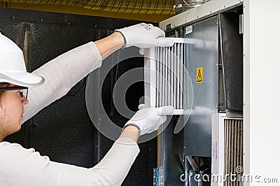 hvac filter replacement home central air system. servicemen changing filter in furnace. Stock Photo