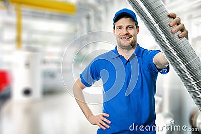 Hvac technician with flexible aluminum ducting tube in hand Stock Photo