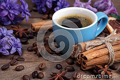 Hyacinth flowers, cup of coffee and spices on a wooden table Stock Photo