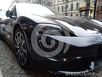 Hybrid Porsche Panamera 4 in a black color on the background of the city Editorial Stock Photo