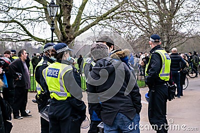 HYDE PARK, LONDON, ENGLAND- 20 March 2021: Protesters being spoken to by police at the Vigil for the Voiceless protest Editorial Stock Photo