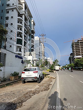 Indian cityscape. newly build tall residential buildings and apartments, people riding vehicles Editorial Stock Photo