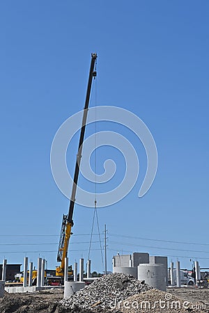 Extended boom from a crane lifting an object Stock Photo