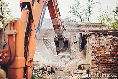 Hydraulic crusher excavator backhoe machinery working on site demolition Stock Photo