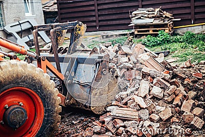 Hydraulic crusher excavator backhoe machinery working on site demolition during renovation works Stock Photo