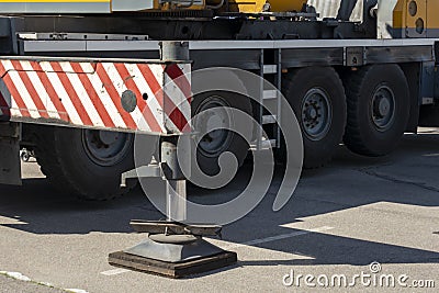Hydraulic foot of the crane. Extended side truck outrigger stabilizer. Support to mobile telescopic crane. close-up Stock Photo