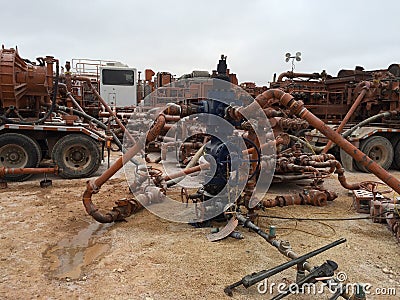 Permain Wellhead With Frac Crew Stock Photo