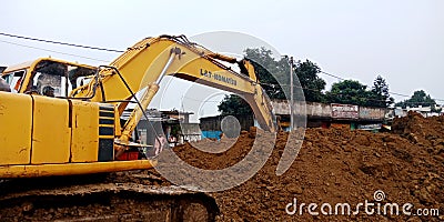 hydraulic machine digging soil for road construction work in India aug 2019 Editorial Stock Photo
