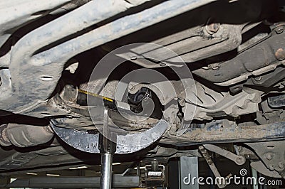 A hydraulic rack supports the front subframe of the car Stock Photo