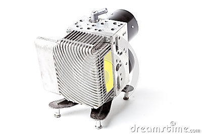 A hydraulic unit with a cooling radiator made of tubes and plates is a spare part for replacement in a auto during repair in a car Stock Photo