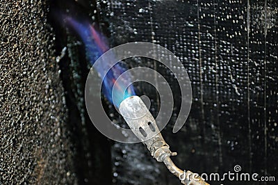 Hydro isolation of house with butane torch Stock Photo