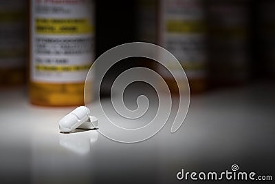 Hydrocodone Pills and Prescription Bottles Under Spot Light. Stock Photo