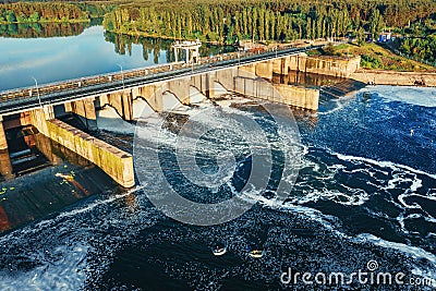 Hydroelectric dam or hydro power station at water reservoir, aerial view from drone. Draining water through gate Stock Photo