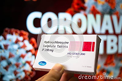 Hydroxychloroquine Sulphate tablets with coronavirus written in background Editorial Stock Photo