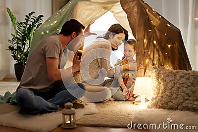 Father telling scary stories to his daughter Stock Photo