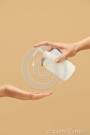 Hygiene. Hands Using Liquid Soap For Coronavirus Prevention Against Beige Background. Daily Routine With Antibacterial Products Stock Photo