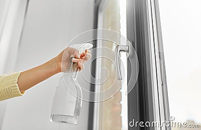 Hands cleaning window handle with detergent Stock Photo