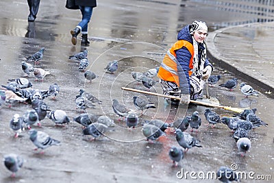 Hygiene worker pigeons Saint Petersburg. Editorial Stock Photo