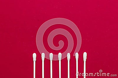 Hygienic, cotton buds on a red background. The concept of hygiene, cleanliness Stock Photo