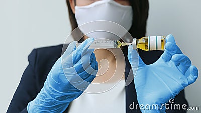 Hygine hand with doctor glove pulling syringe of vaccine drug Stock Photo