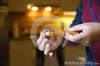 Hyperglycemic diabetic patient opening her insulin shot Stock Photo