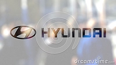 Hyundai Motor Company logo on a glass against blurred crowd on the steet. Editorial 3D rendering Editorial Stock Photo