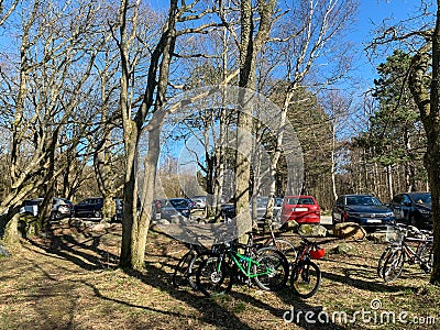 HÃ¶NÃ¶, SWEDEN - Apr 10, 2020: A full parking lot with many cars and bicycles Editorial Stock Photo