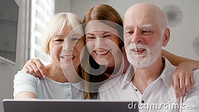 Höga par och deras dotter som hemma sitter samtal via budbäraren Skype Le att skratta stock video Höga par och deras dotter som hemma sitter samtal via budbäraren Skype Le att skratta stock video