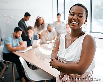 I absolutely love working here. Cropped portrait of an attractive young businesswoman attending a meeting in the Stock Photo