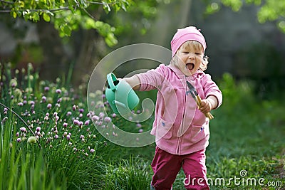 I adore country life. Child is in a hurry to start gardening Stock Photo