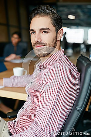 I begin with ideas, and then it becomes something else. Portrait of an office worker in a meeting with colleagues in the Stock Photo