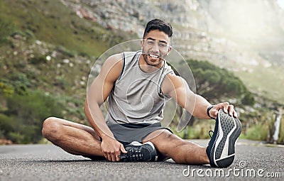 I can feel the difference after stretching. an athletic young man stretching on a mountain road. Stock Photo