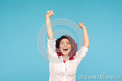 I am champion! Portrait of energetic enthusiastic woman with fancy red hair in shirt raising hands and shouting Stock Photo