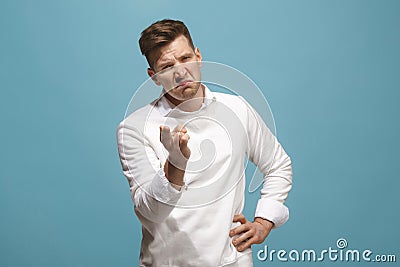 The overbearing businessman point you and want you, half length closeup portrait on blue background. Stock Photo