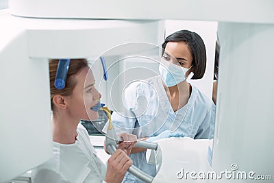 Delighted dentist watching her patient Stock Photo