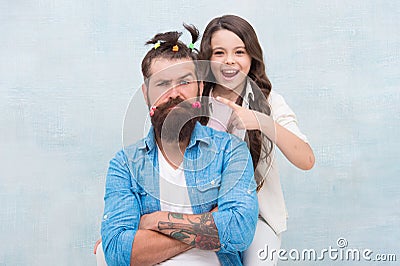 I did it. little girl made funny hairstyle for daddy. daughter and dad playing together. hairstylist her future career Stock Photo