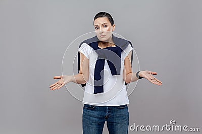 I Don`t Know. Handsome casual styled woman with blue jeans and s Stock Photo