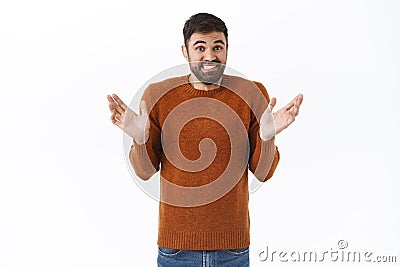 I dont know, sorry cant help. Portrait of awkward and clumsy cute bearded guy apologizing for making mess, raise hands Stock Photo