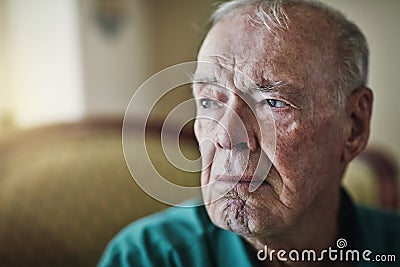 I dont need much, just your time. a senior man sitting by himself in a living room. Stock Photo