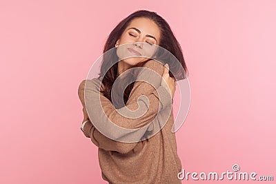 I am egoist, love myself! Portrait of selfish narcissistic young woman with brunette hair embracing herself Stock Photo