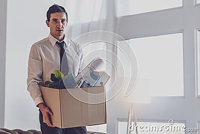 Depressed cheerless man holding a box Stock Photo
