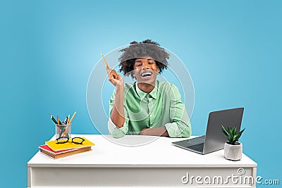 I have great idea. Excited african american guy pointing pencil up, thinking and finding inspiration, sitting at desk Stock Photo