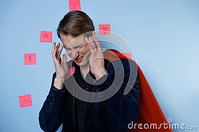 I have a headache from multitasking, perfectionism and a large number of tasks at work. Stock Photo