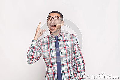 I have idea. happy amazed handsome bearded businessman in colorful checkered shirt, blue tie and black eyeglasses standing and lo Stock Photo