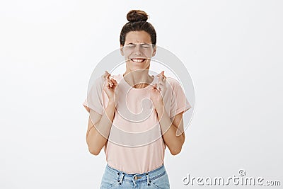 I have to win. Woman putting effort to pray and make wish as wanting receive award crossing fingers for good luck Stock Photo