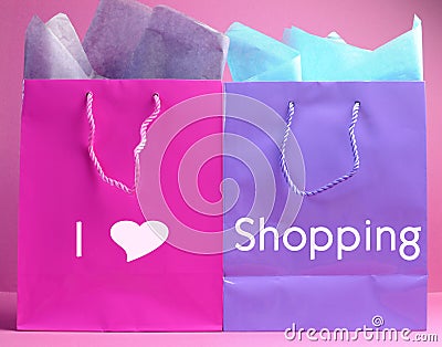 I Heart (Love) Shopping message on pink and purple shopping bags. Stock Photo